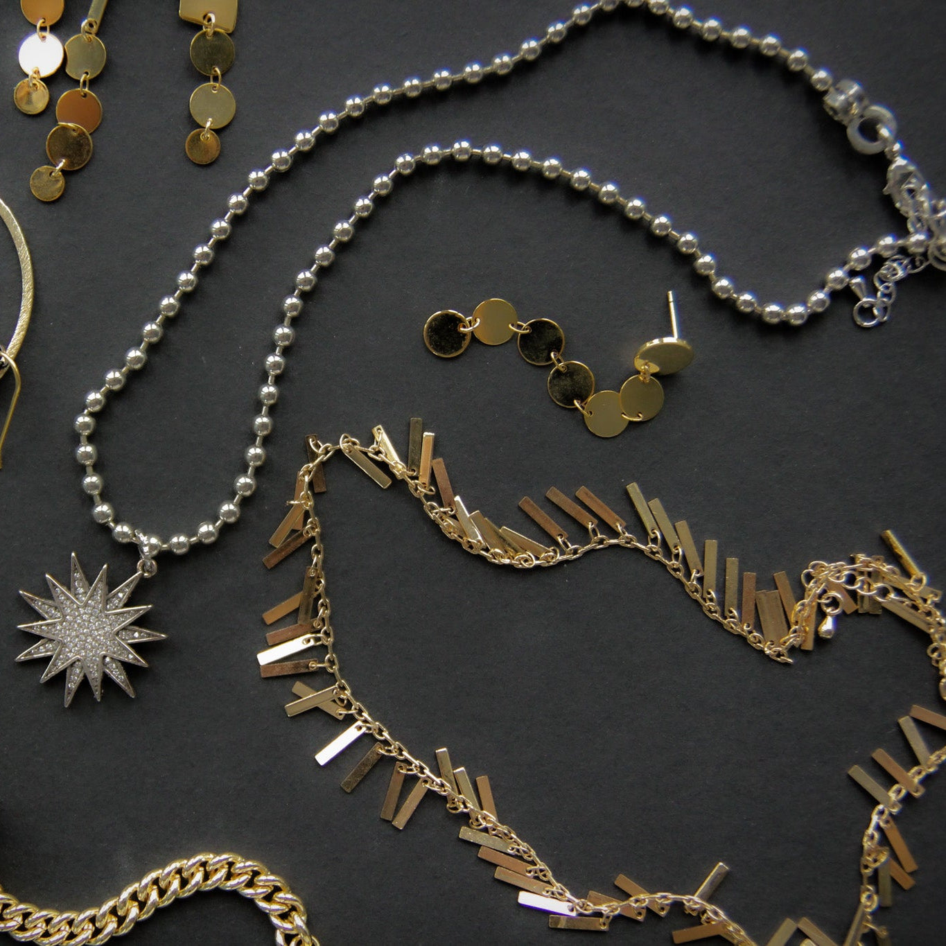 Collection of various jewelry items on a dark surface