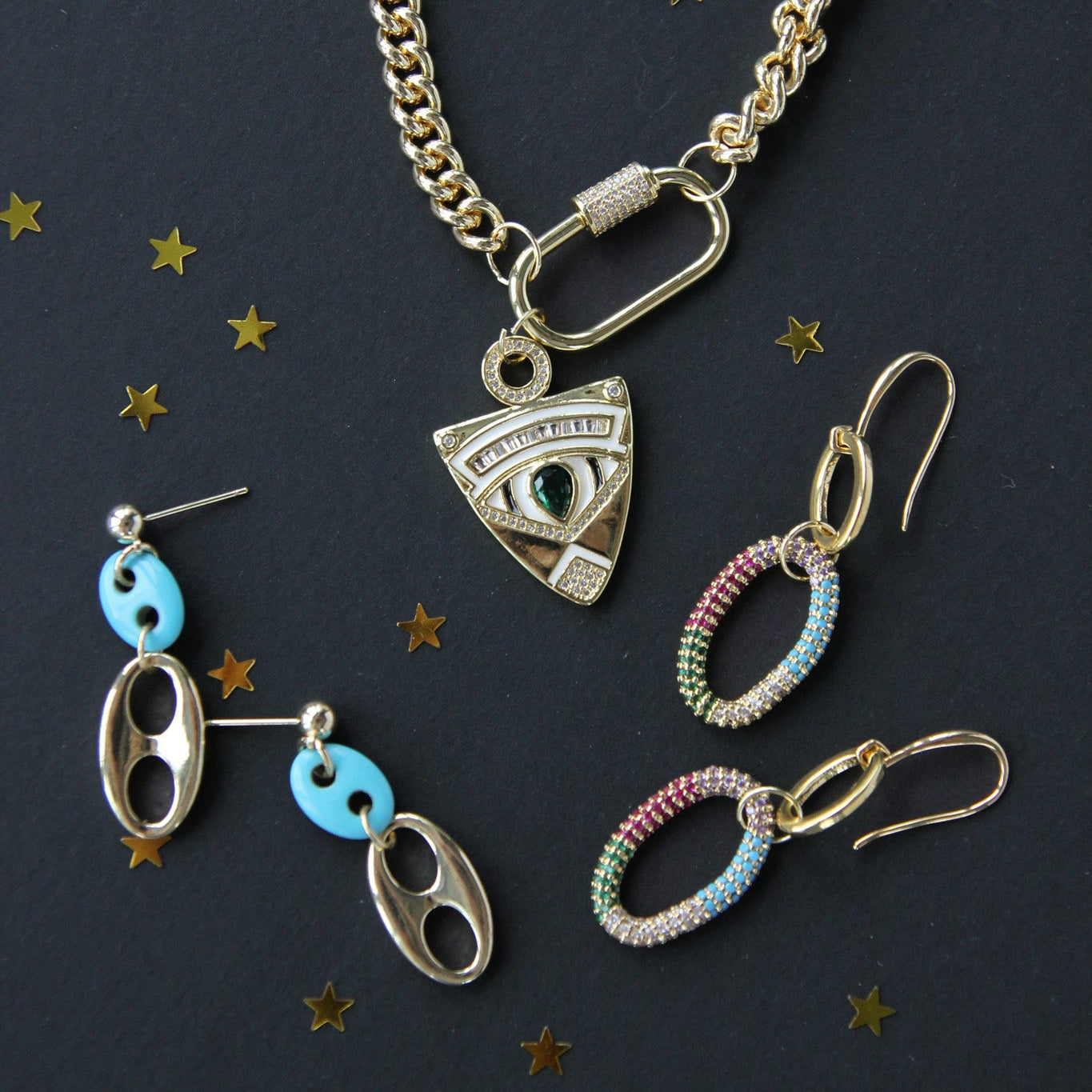 Jewelry set including a necklace and earrings on a dark background with star-shaped decorations.