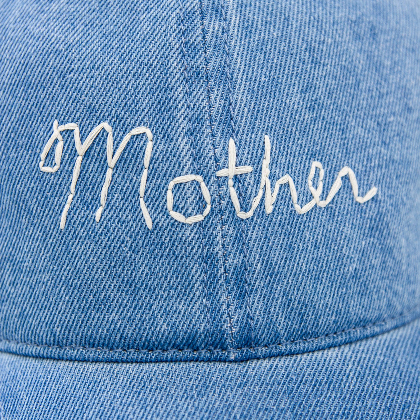 Blue denim cap with 'Mother' embroidered on it