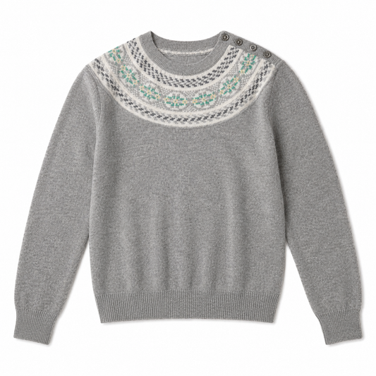 A gray knit sweater with a decorative yoke featuring gray, white, and turquoise geometric patterns, three metal snap buttons at the collar, and ribbed cuffs and hem.